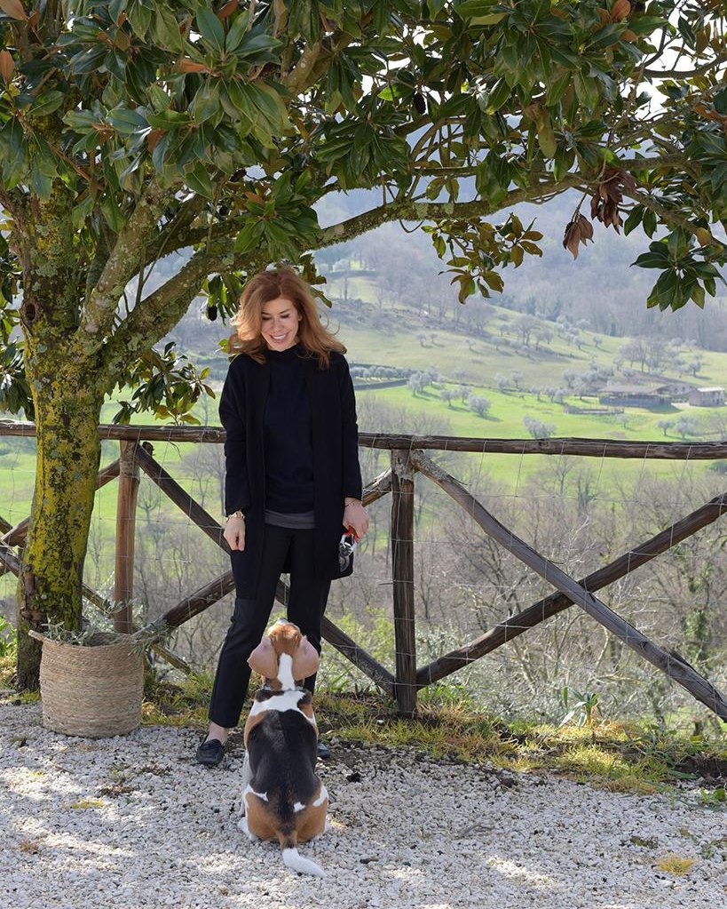 Francesca with her beagle Greta, under a magnolia above the valley