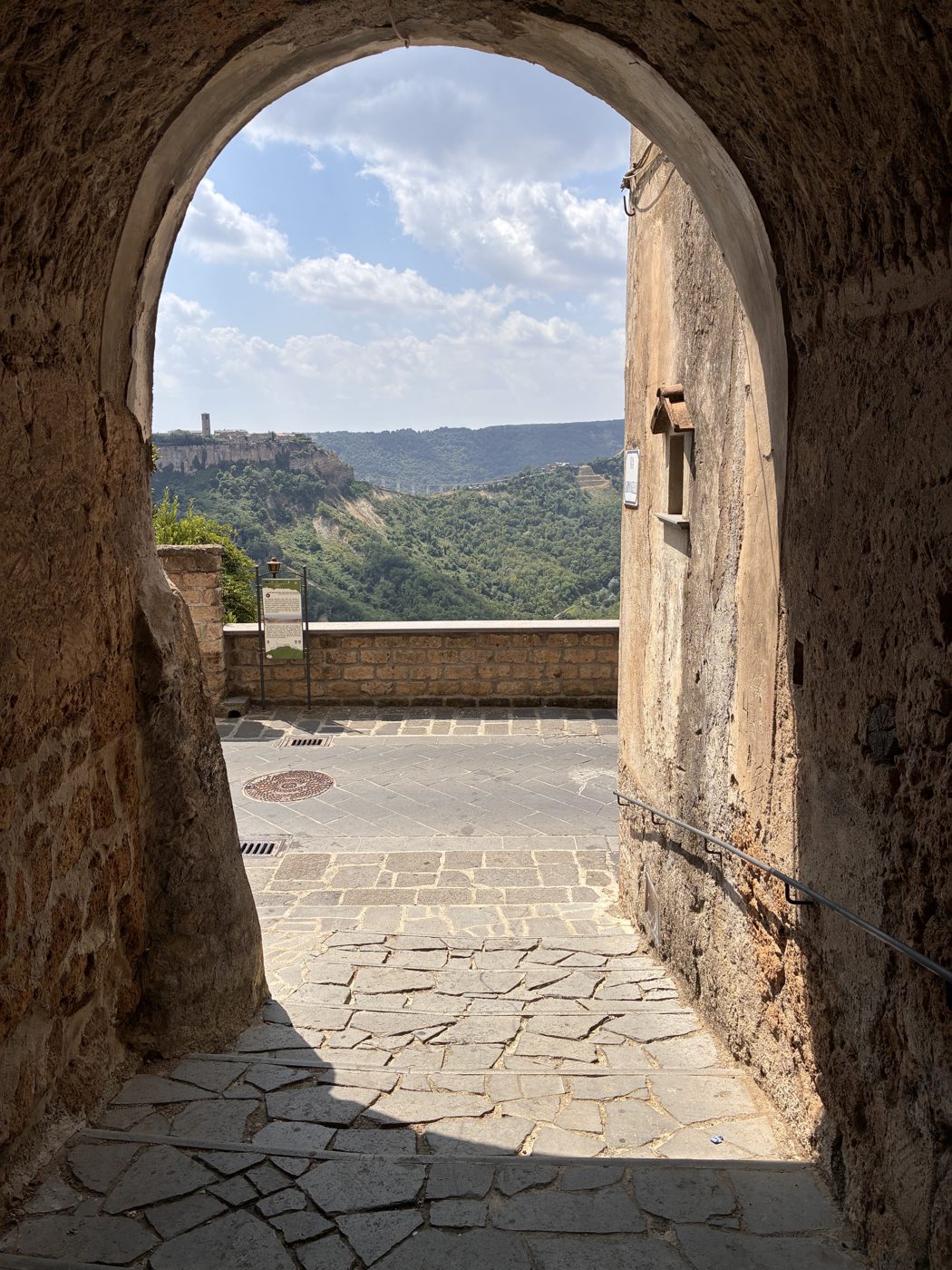 The valley seen through a stone archway in Civita