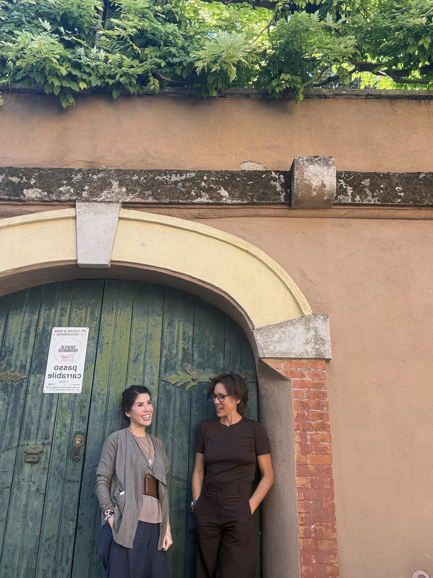 Francesca and Jade in front of an old green door
