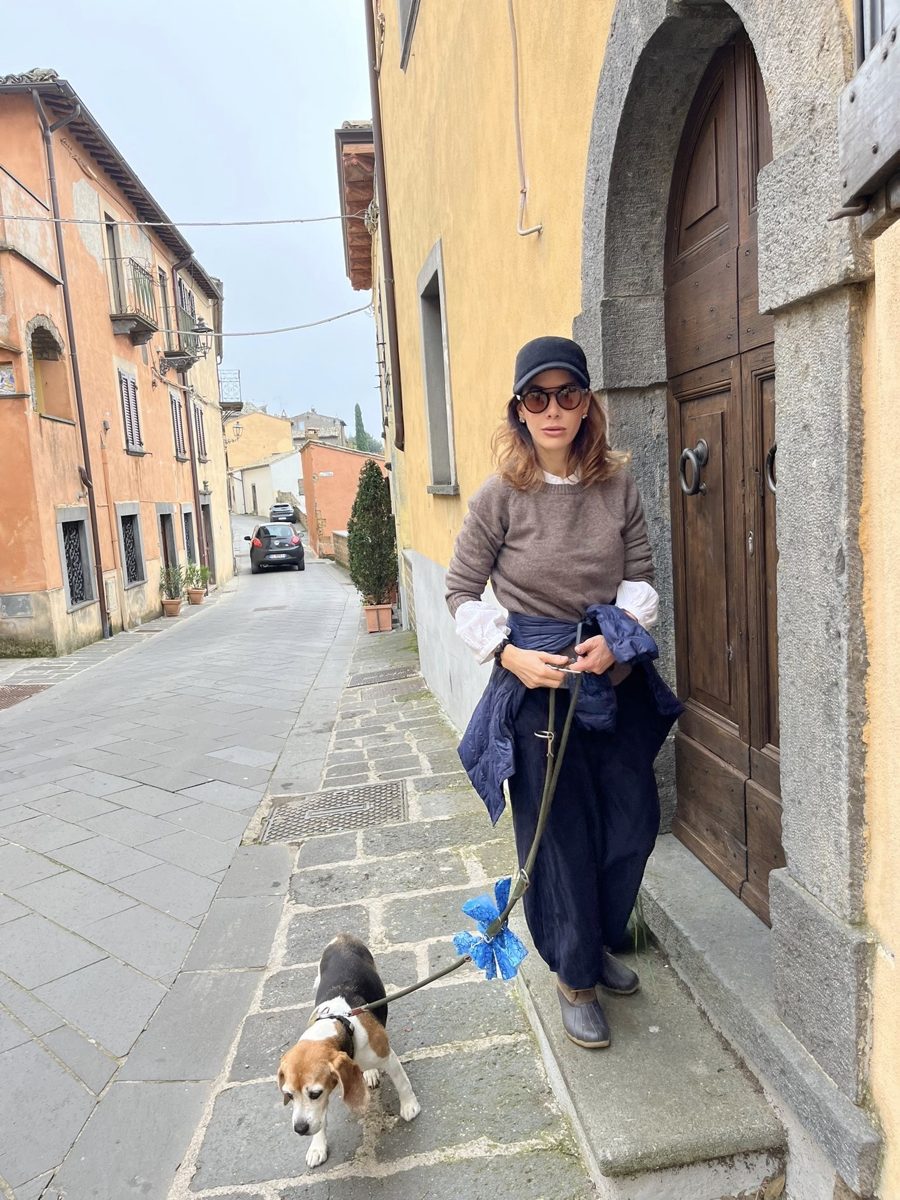 Francesca with her dog at a front door in the village
