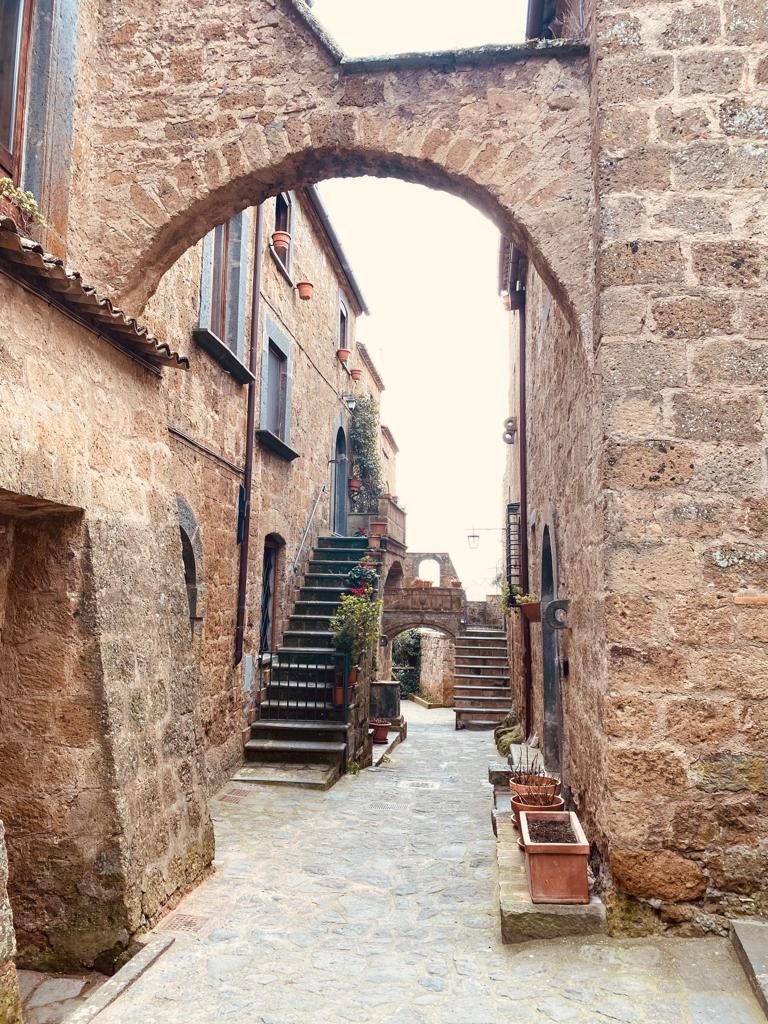A stone lane under an arch in Civita